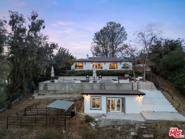 view of back house at dusk