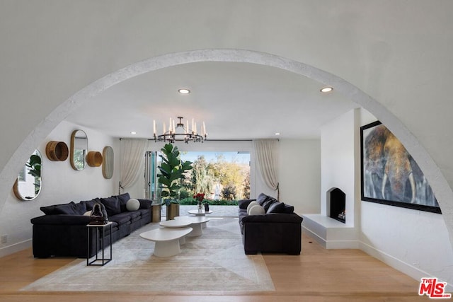 living room featuring light hardwood / wood-style flooring and a notable chandelier