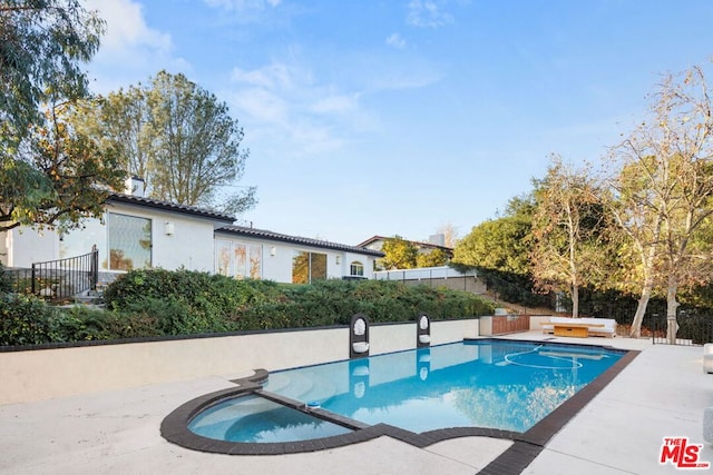 view of pool featuring an in ground hot tub and a patio