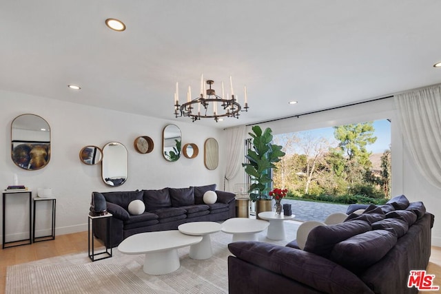 living room featuring light hardwood / wood-style floors and a chandelier