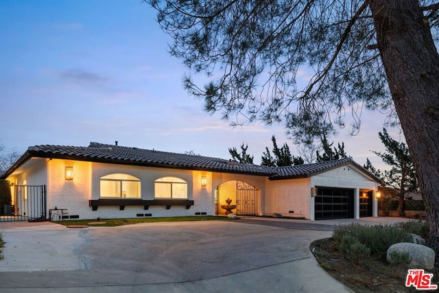 mediterranean / spanish house featuring a garage