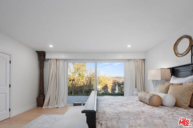 bedroom with light hardwood / wood-style flooring and access to outside