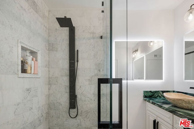 bathroom featuring vanity and a tile shower