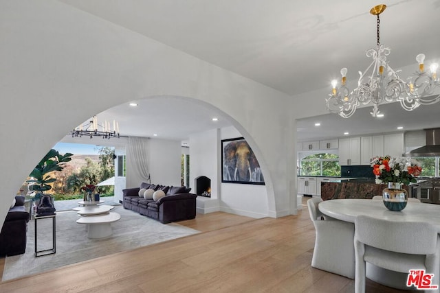 living room featuring an inviting chandelier and light hardwood / wood-style flooring