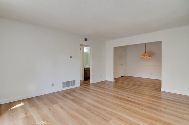 spare room featuring light wood-type flooring