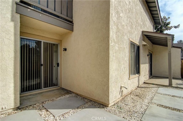 entrance to property with a patio