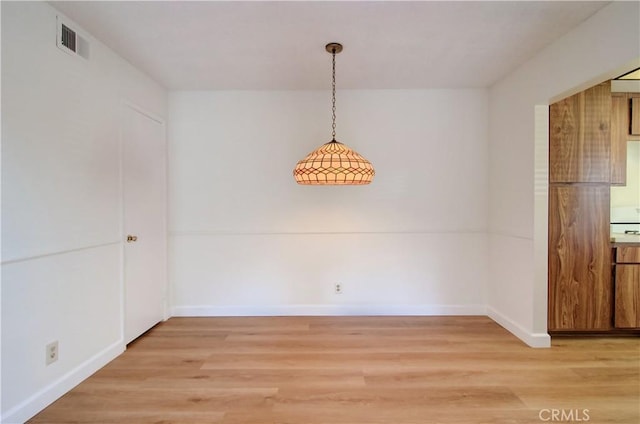 unfurnished dining area featuring hardwood / wood-style flooring