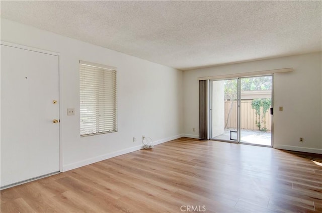 interior space featuring a textured ceiling and light hardwood / wood-style floors