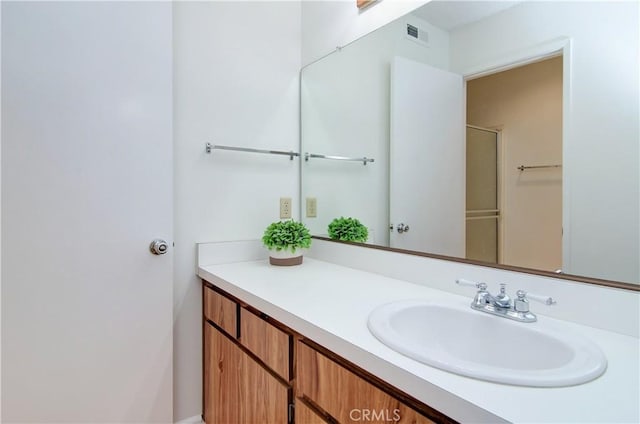 bathroom with an enclosed shower and vanity