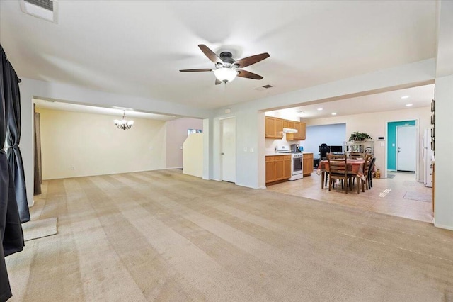 carpeted living room with ceiling fan with notable chandelier