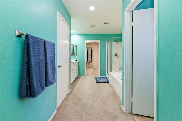 bathroom featuring vanity and plus walk in shower