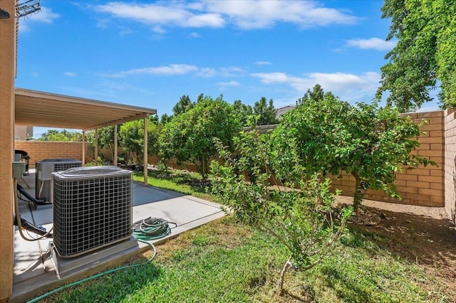 view of yard with central air condition unit and a patio area