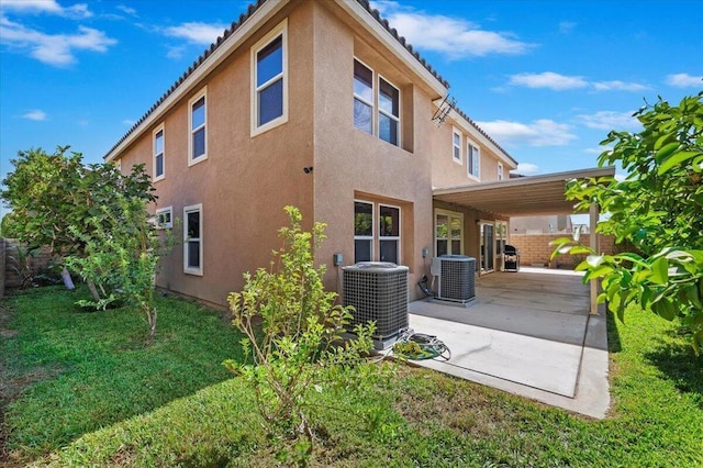 back of house featuring a patio area, central AC unit, and a lawn