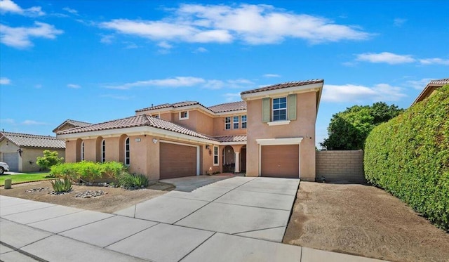 mediterranean / spanish-style home with a garage