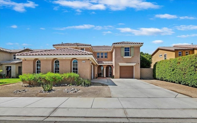 mediterranean / spanish-style home with a garage