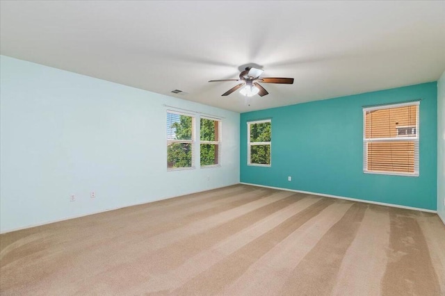 unfurnished room with ceiling fan and light carpet