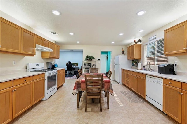 kitchen featuring sink and white appliances