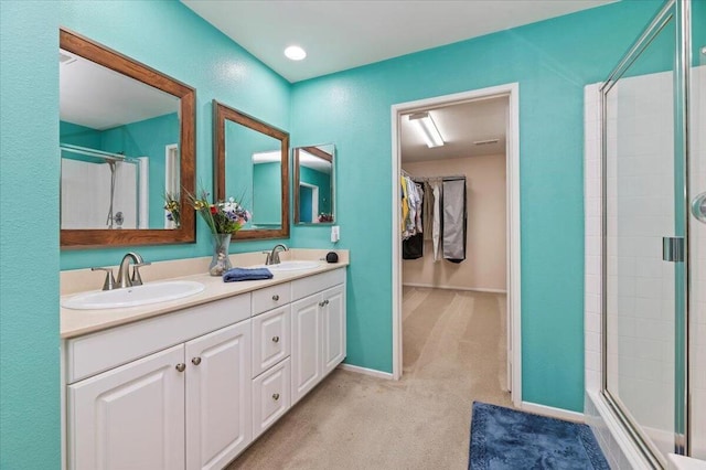 bathroom featuring vanity and a shower with door