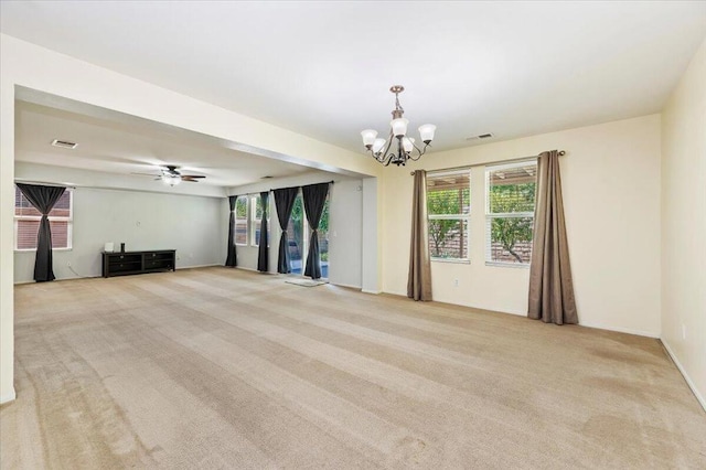 unfurnished living room with light carpet and ceiling fan with notable chandelier