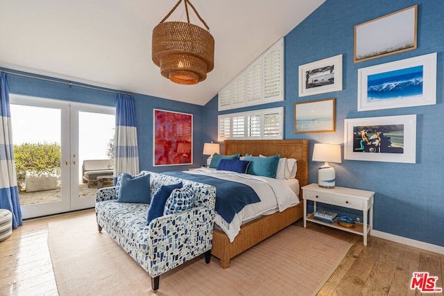 bedroom featuring access to exterior, vaulted ceiling, french doors, and wood-type flooring