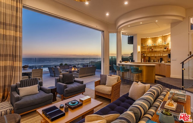 living room with a water view and bar area