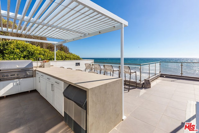 view of patio / terrace with a grill, a view of the beach, exterior bar, a water view, and a pergola