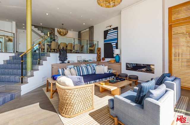 living room featuring hardwood / wood-style floors and an inviting chandelier