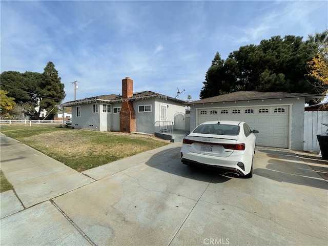 ranch-style home featuring a front lawn and a garage