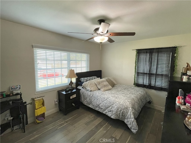 bedroom with ceiling fan and dark hardwood / wood-style flooring