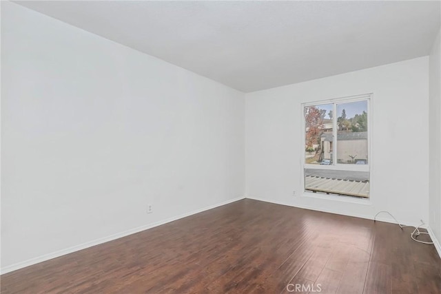 spare room with dark hardwood / wood-style floors