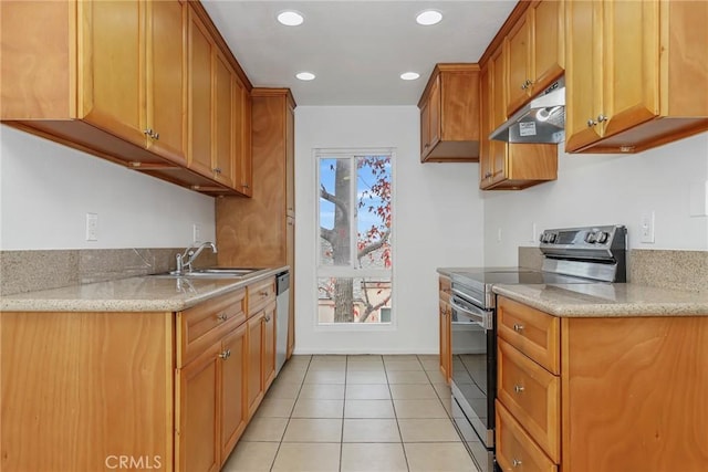 kitchen featuring a healthy amount of sunlight, sink, light tile patterned floors, and stainless steel appliances