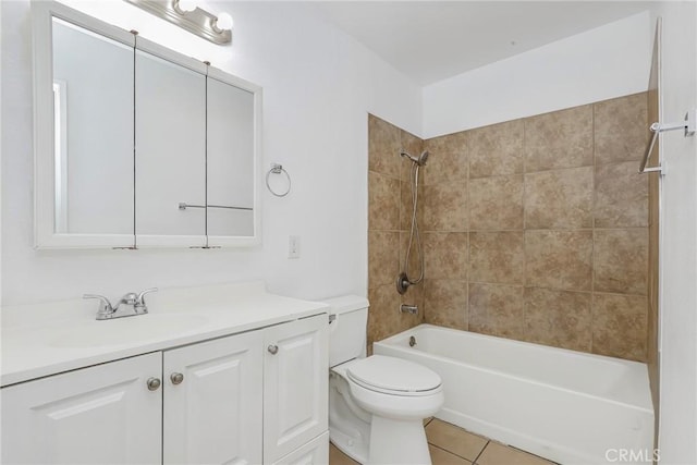 full bathroom featuring toilet, tiled shower / bath combo, tile patterned flooring, and vanity