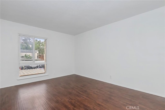 spare room with dark hardwood / wood-style flooring