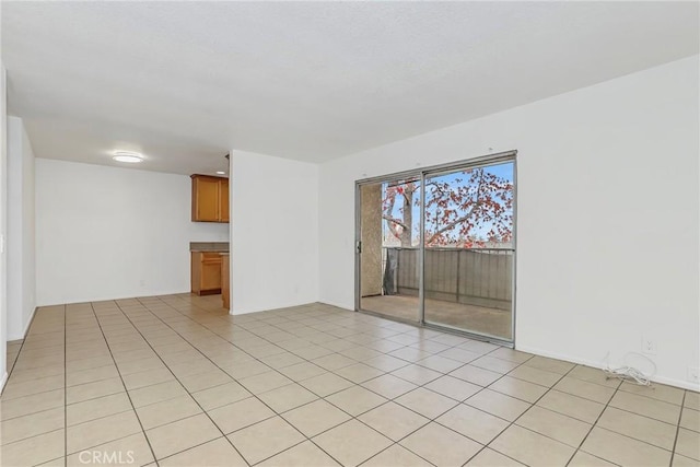 unfurnished room featuring light tile patterned floors