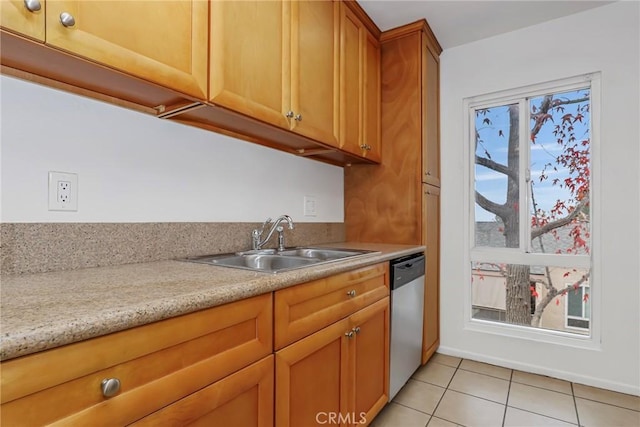 kitchen with light stone countertops, light tile patterned floors, stainless steel dishwasher, and sink