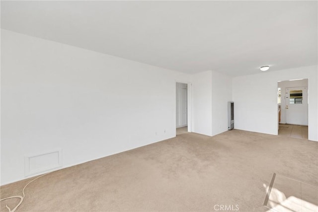 unfurnished room with light carpet