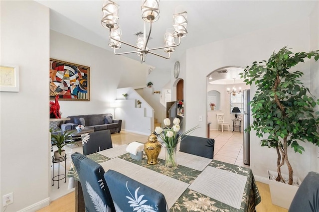 tiled dining room featuring a chandelier