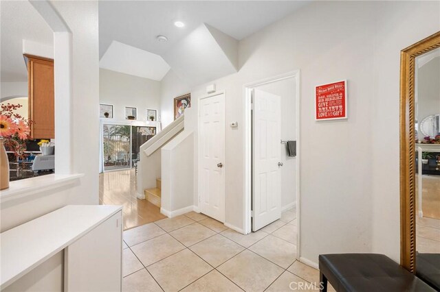 tiled entrance foyer with vaulted ceiling