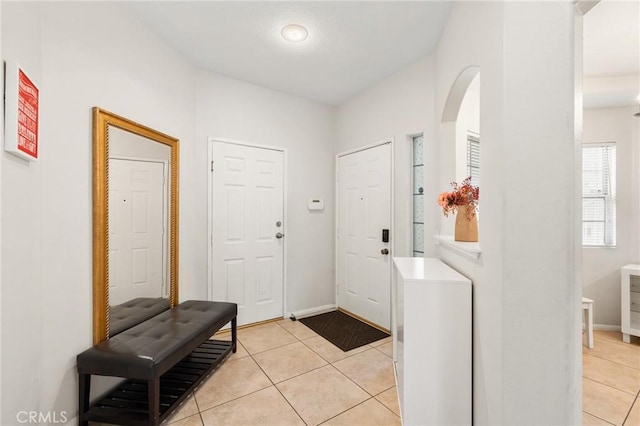 foyer entrance with light tile patterned floors