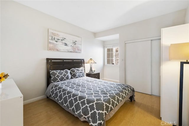 bedroom featuring a closet and light hardwood / wood-style flooring