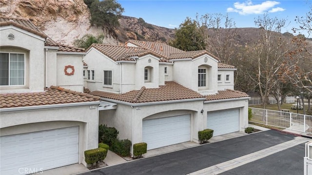 mediterranean / spanish home with a mountain view and a garage