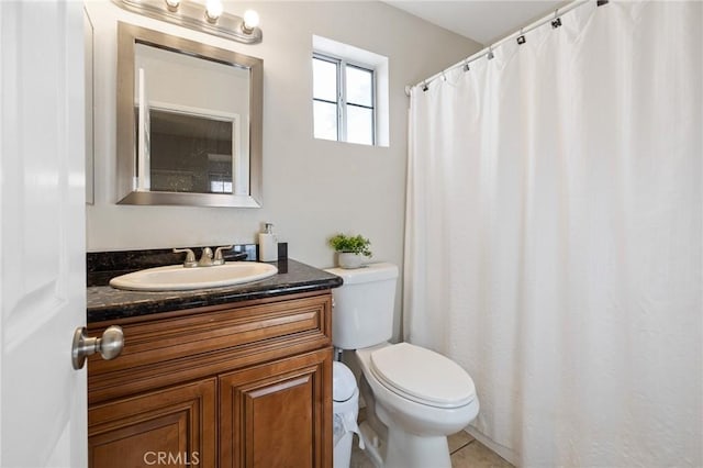 bathroom with toilet, tile patterned flooring, and vanity