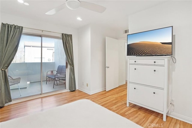 unfurnished bedroom featuring ceiling fan, wood-type flooring, and access to outside