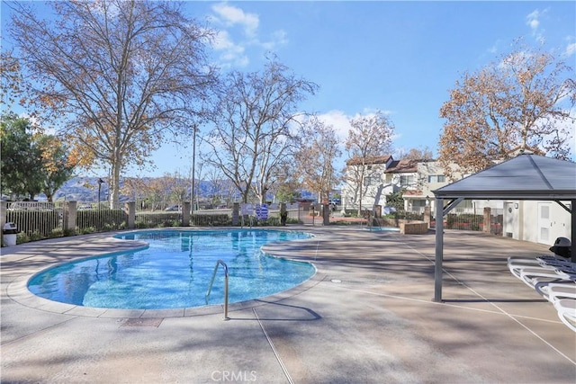 view of swimming pool with a gazebo and a patio