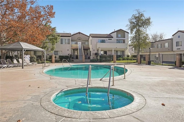 view of pool with a gazebo, a hot tub, and a patio