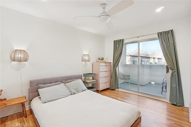 bedroom featuring ceiling fan, hardwood / wood-style floors, and access to outside