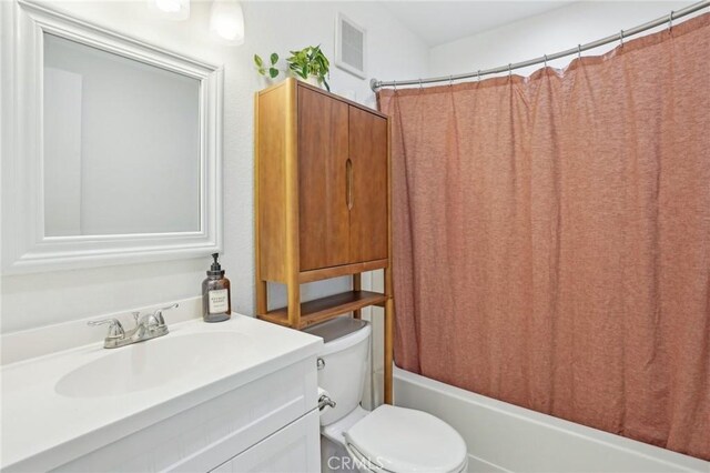 full bathroom featuring toilet, shower / bath combination with curtain, and vanity