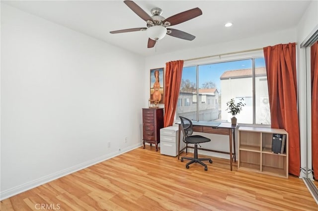 home office featuring light wood-type flooring and ceiling fan