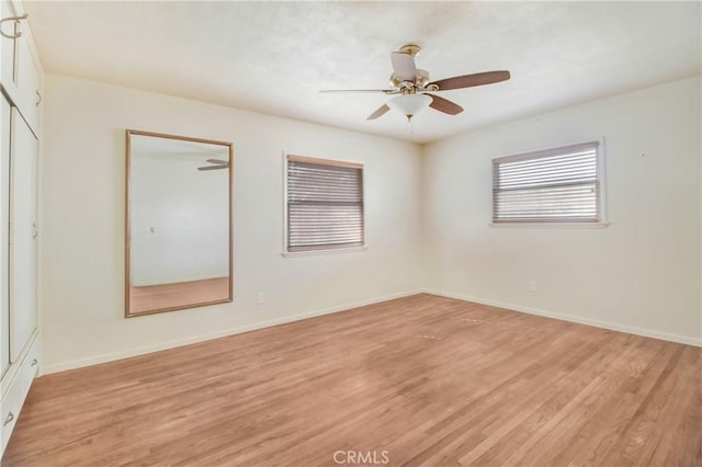 empty room featuring ceiling fan and light hardwood / wood-style flooring