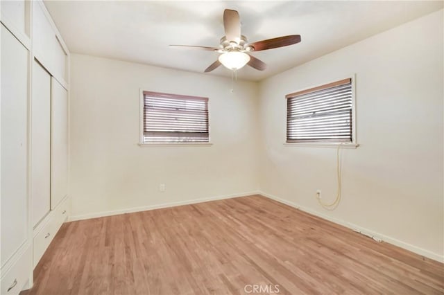 unfurnished bedroom with ceiling fan, light hardwood / wood-style floors, and a closet